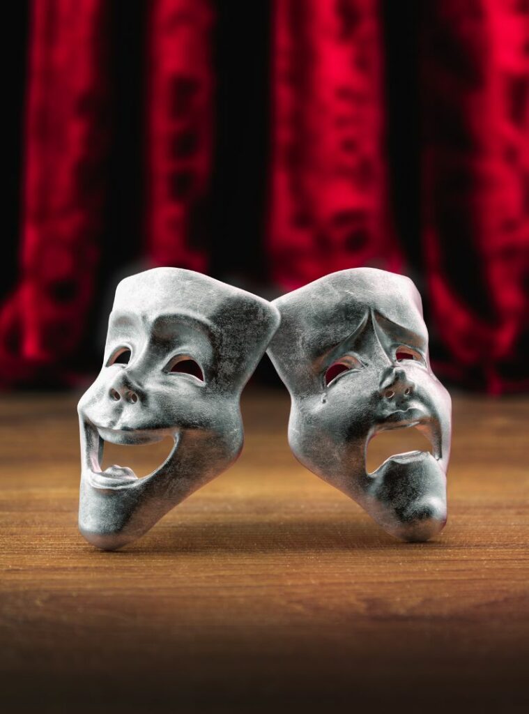 Dwie teatralne maski na tle sceny jako symbol profilu teatralnego.